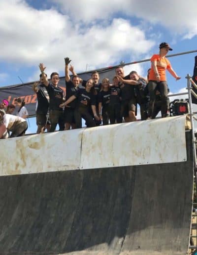 People at the top of a mud hill