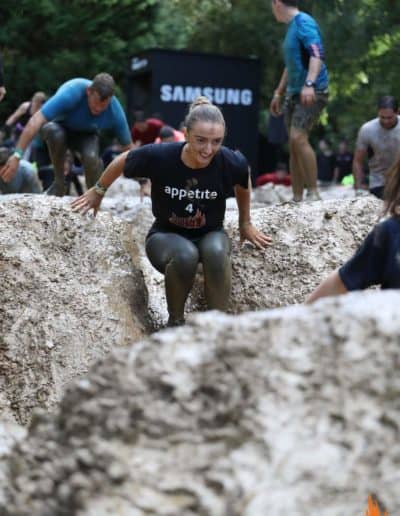 Woman sliding down mud